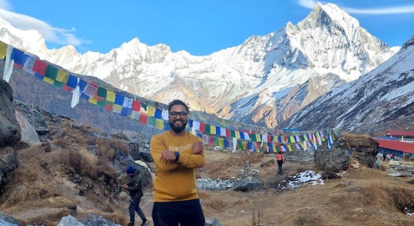 Happy trekkers posing at Annapurna Base Camp with mountain views