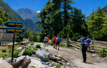 Annapurna Circuit Trek trail to Upper Pisang with trekkers and Himalayan mountain views Annapurna Circuit Trek trail to Upper Pisang with trekkers and Himalayan mountain views