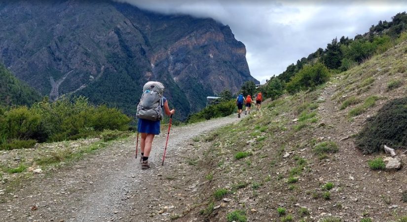 Annapurna Circuit Trek trail near Upper Pisang with trekkers and Himalayan mountain views