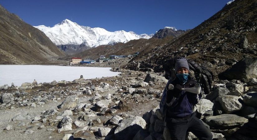 Strong porter carrying luggage near by Gokyo trek 