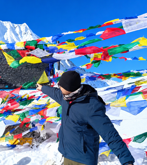 Trekkers walking along a trail with snow-capped Himalayan peaks on the Manaslu Circuit Trek in Nepal