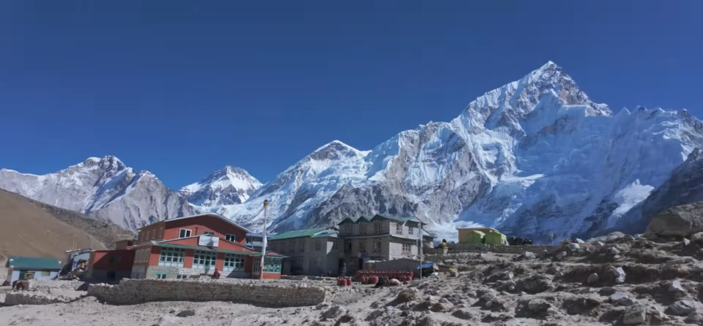 Everest Base Camp Trek by Road; Trekkers walking towards Everest Base Camp with Mount Everest in the background