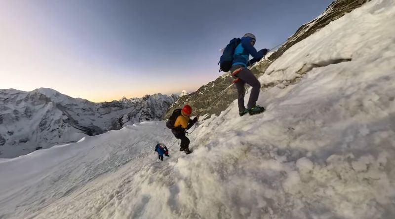 Island Peak climbing expedition in the Himalayas of Nepal with snowy mountain peaks and climbers ascending glacier terrain.