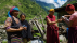Traditional mountain village scene with local people and trekkers in the Himalayas